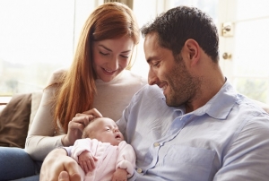 Mother And Father At Home With Newborn Baby