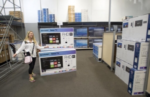 Sloan Dalley, of Pomona, gets excited as she finds one of the few remaining 55-inch Samsung television at Best Buy in Metro Pointe in Costa Mesa, Calif., on Black Friday, Nov. 25, 2016. Stores are trying to better cater to savvier shoppers, who are splitting their spending back and forth online and in stores. That was apparent on Black Friday, the day after Thanksgiving, as shoppers were careful about what deals they'd jump at and retailers pushed different ways to connect with customers. (Jeff Gritchen /The Orange County Register via AP)